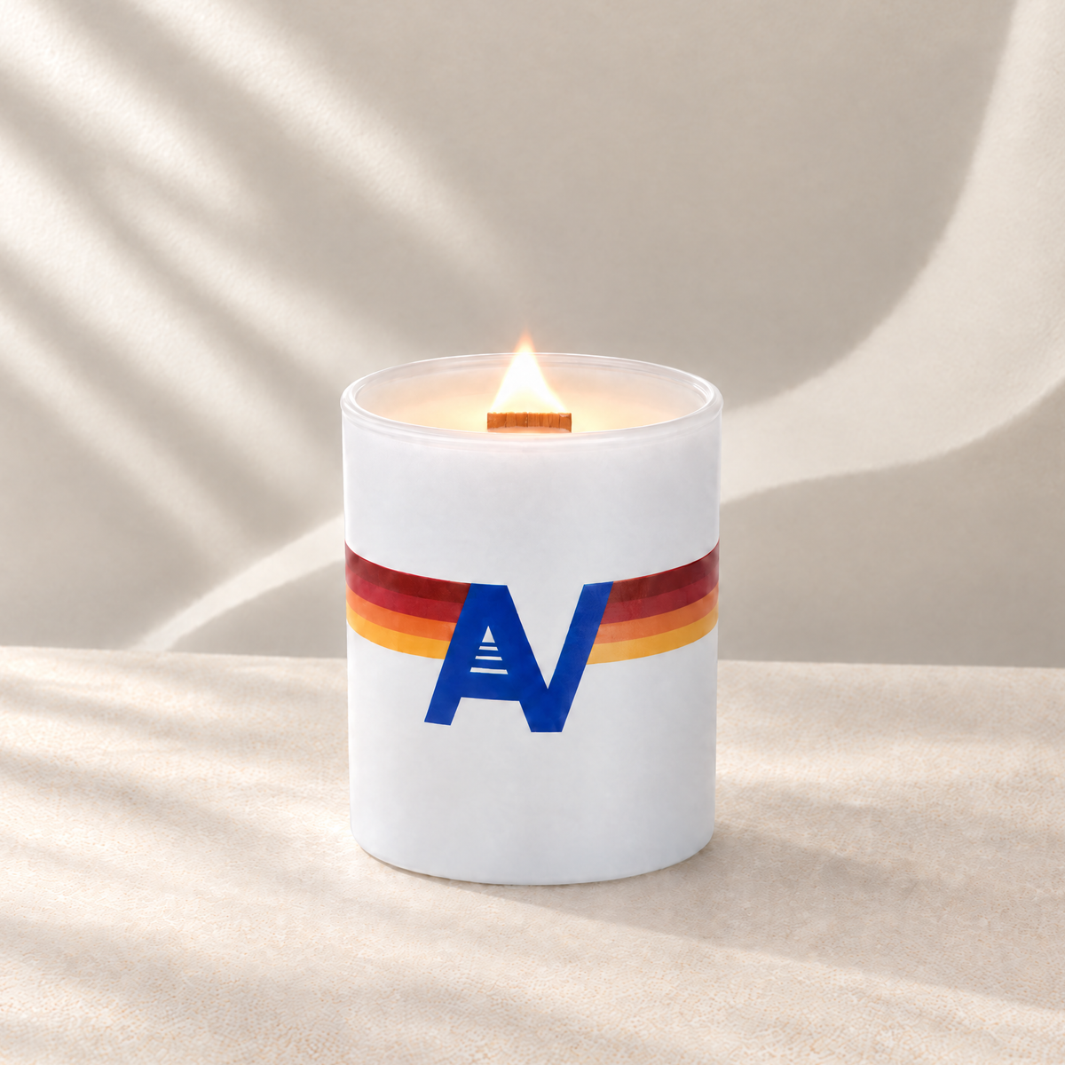 Matte White 14 oz. Luxury Printed Candle lit with a printed custom logo, shown on a matching white background.