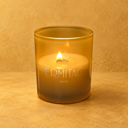 Yellow 14 oz. Luxury Engraved Candle with a custom engraved logo, lit.
