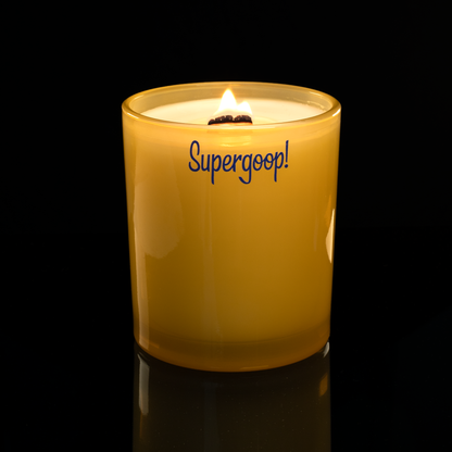 Yellow 14 oz. Luxury Printed Candle lit, shown on a black background.
