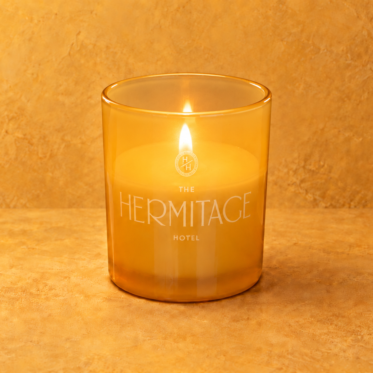 Yellow 9 oz. Classic Engraved Candle with a custom engraved logo, lit.