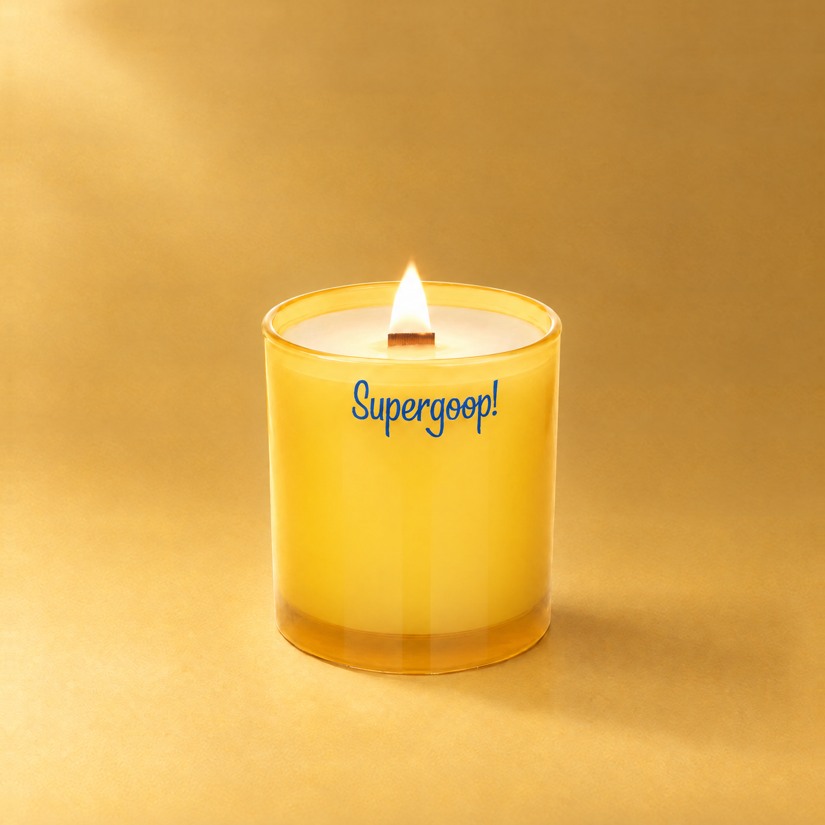 Yellow 14 oz. Luxury Printed Candle lit with a printed custom logo, shown on a matching yellow background.
