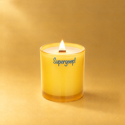 Yellow 14 oz. Luxury Printed Candle lit with a printed custom logo, shown on a matching yellow background.