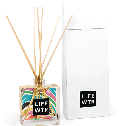 8 oz clear glass reed diffuser bottle with natural wooden reeds and custom logo printing, shown with white packaging box