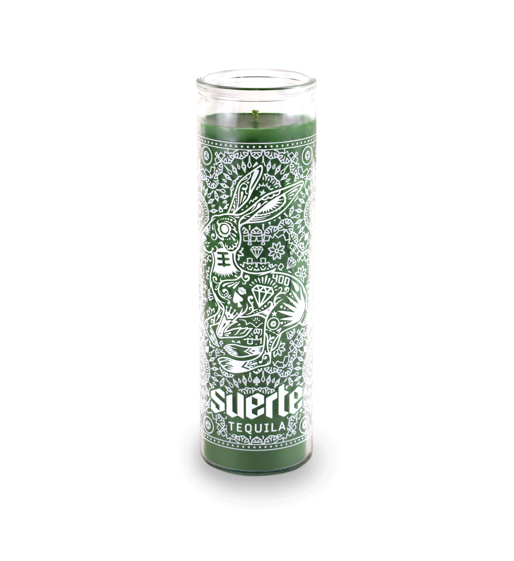 A 16 oz Prayer Candle from Custom Candles LA filled with green wax in a tall glass container. The candle is printed a logo at the bottom that reads "Suerte Tequila" in white. The logo is surrounded by an ornate pattern that makes the shape of a rabbit. The pattern includes diamonds, dots, flowers, and other line artwork. The green wax shows through the artwork.