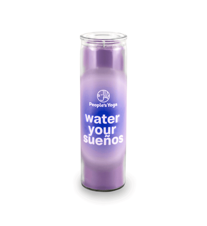 A 16 oz Prayer Candle from Custom Candles LA filled with purple wax in a tall glass container. The candle is printed with a white "People's Yoga" logo and underneath it reads "water your suenos" in white. Behind the letters is a blue circle and fades into a lighter purple color. You can see the purple wax through the glass.