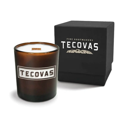Luxury engraved candle with branding next to a box on a white background