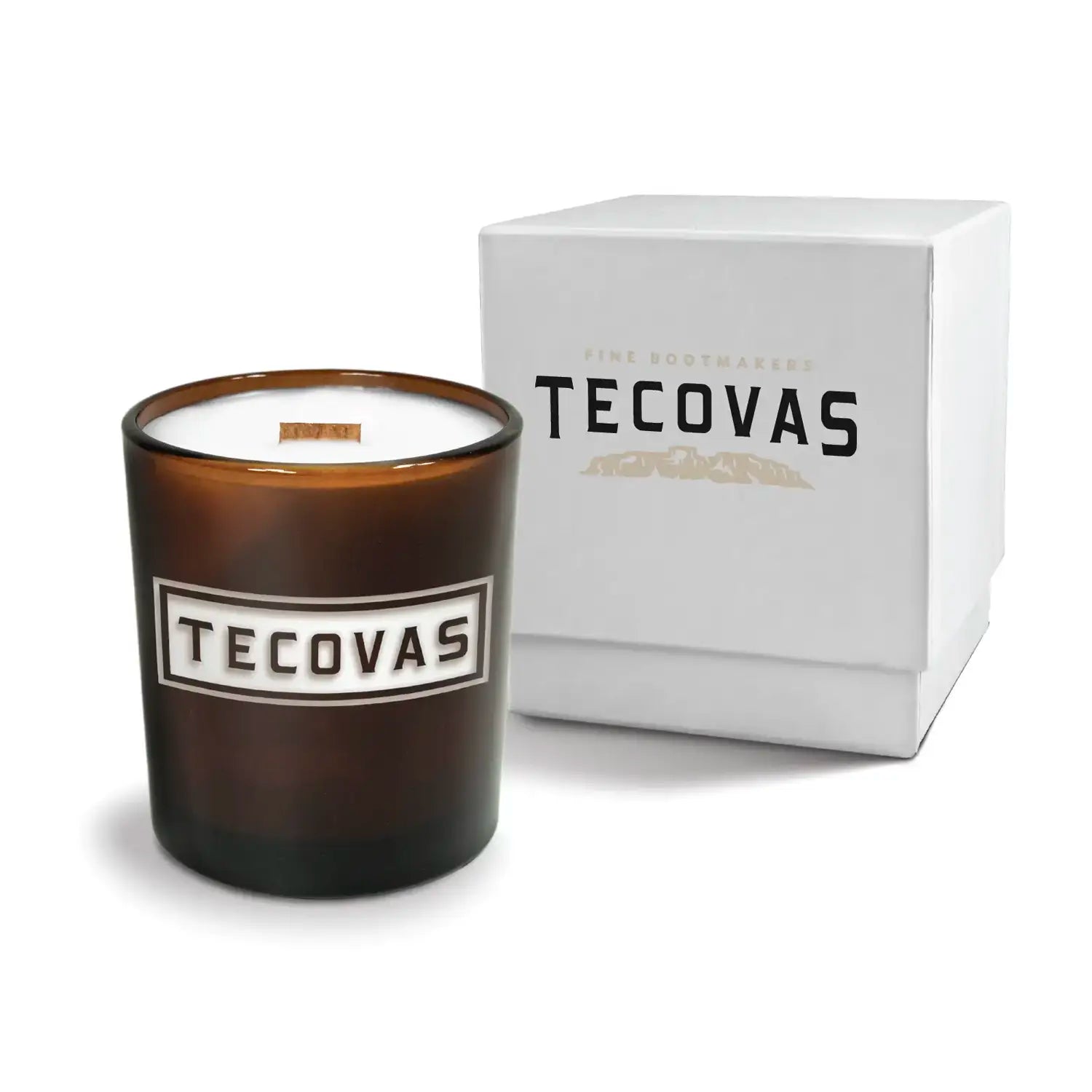Luxury engraved candle with branding next to a box on a white background