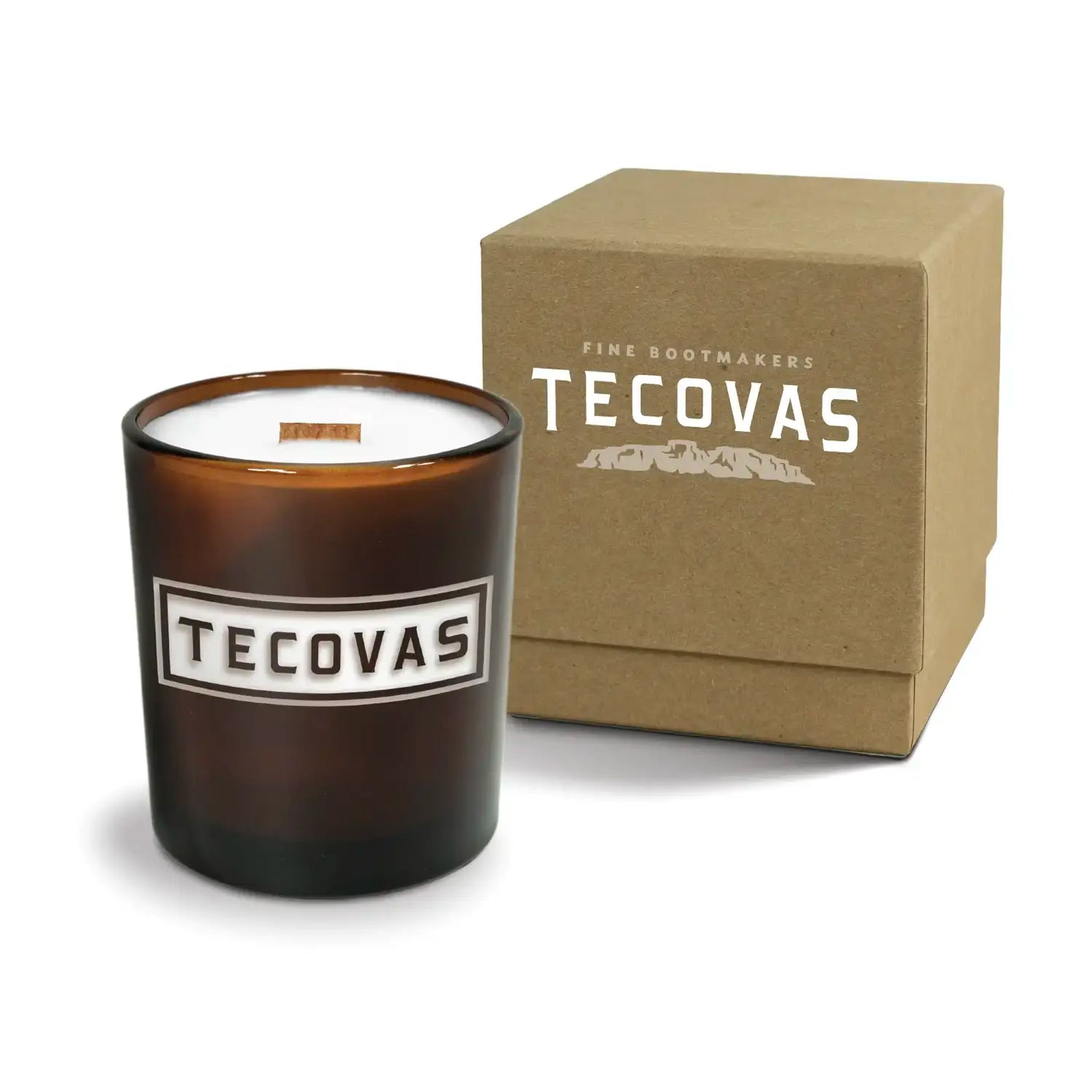 Luxury engraved candle with branding next to a box on a white background
