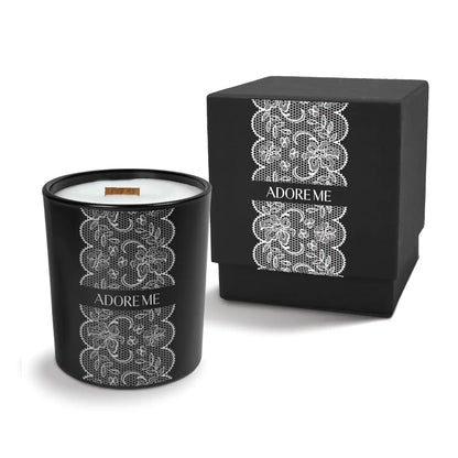 Luxury engraved candle with branding next to a box on a white background