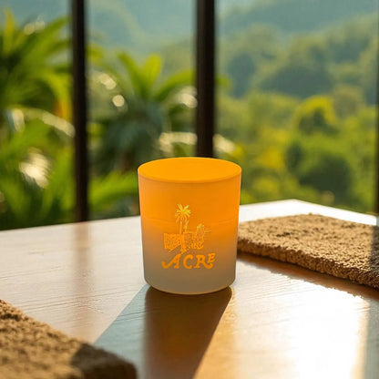 Candle with lit with branding on a table with a scenic background
