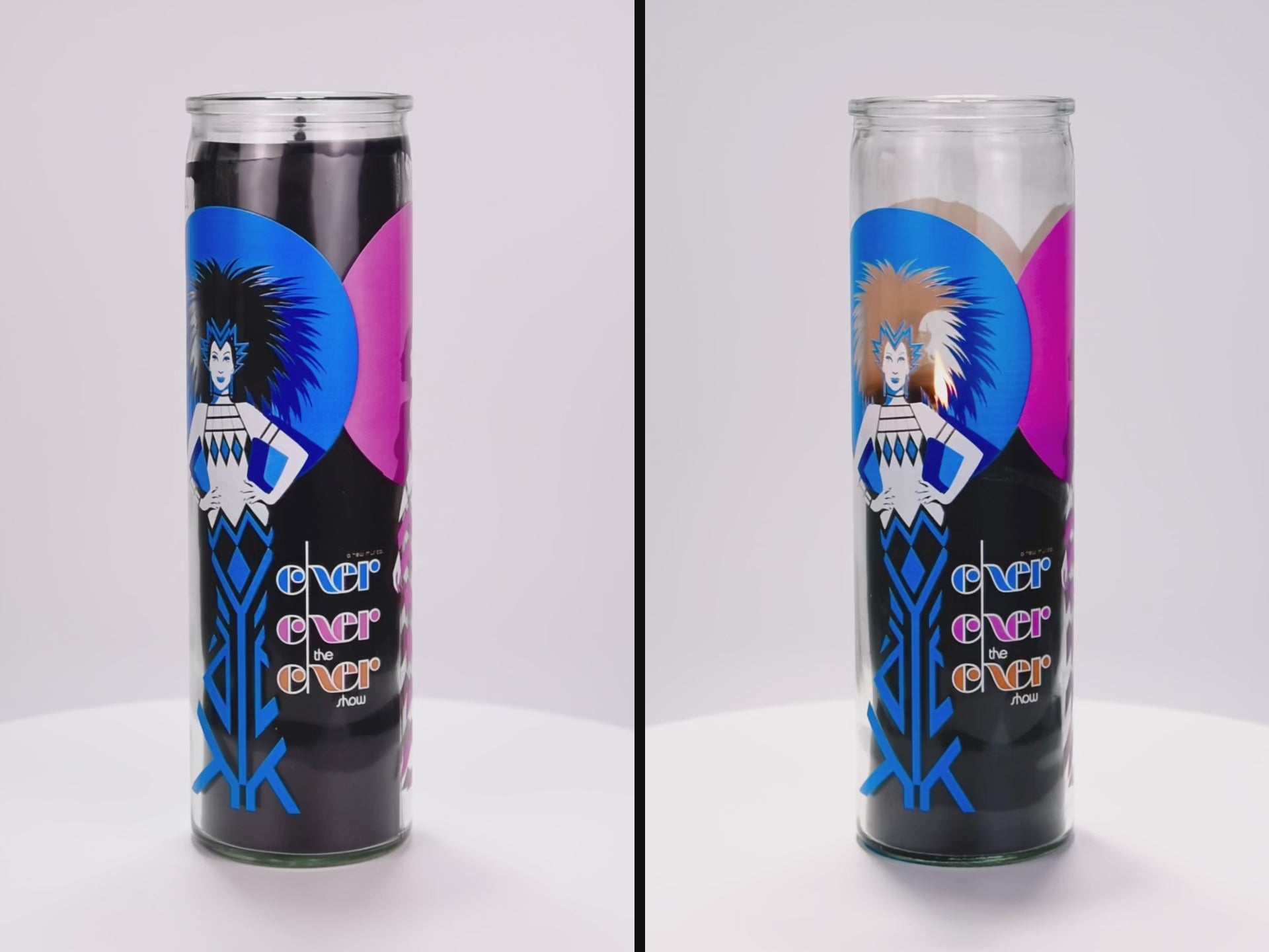 Load video: Two 16 oz Prayer Candles from Custom Candles LA filled with black wax in a tall glass container spinning side by side. The left candle is unlit, and the right candle is lit and burned halfway down. The candles are printed with an image on a woman with spiky hair and her hands on her hips in royal blue and white in front of a blue and a pink circle with the black wax showing through. Next to the woman the glass Is printed with the words &quot;Exer exer the exer show&quot; stacked in blue, pink, and orange. 