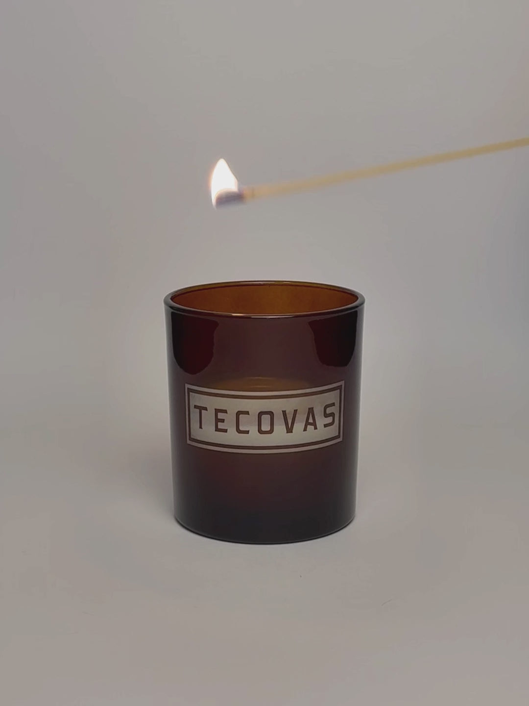 Amber Luxury Engraved Candle being lit product shot.