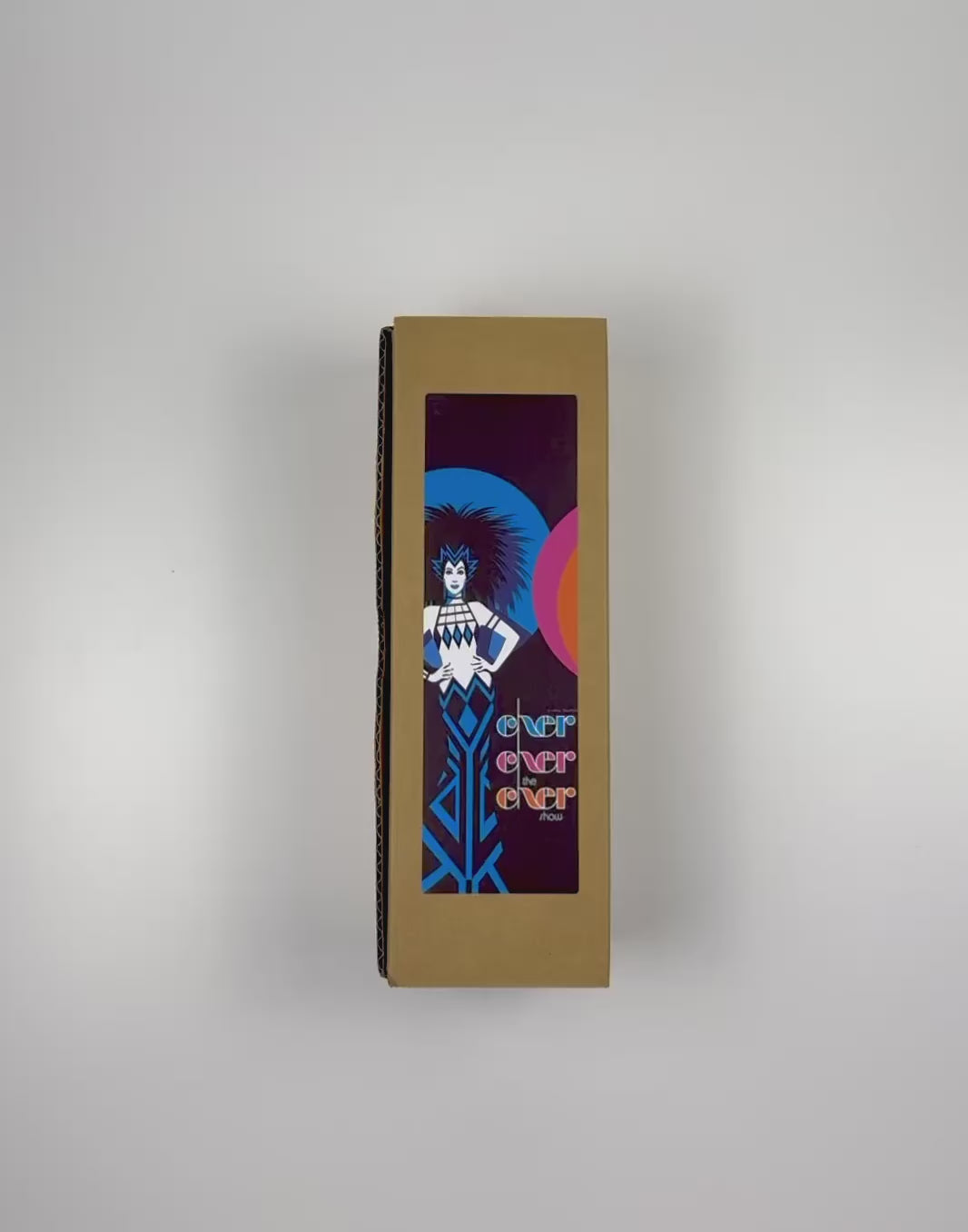 Load video: An unboxing video of the 16 oz Prayer Candle from Custom Candles LA filled with black wax that comes in a Kraft mailer box with a colorful sticker label of logo artwork. The candle is printed with an image on a woman with spiky hair and her hands on her hips in royal blue and white in front of a blue and a pink circle with the black wax showing through. Next to the woman the glass Is printed with the words &quot;Exer exer the exer show&quot; stacked in blue, pink, and orange.