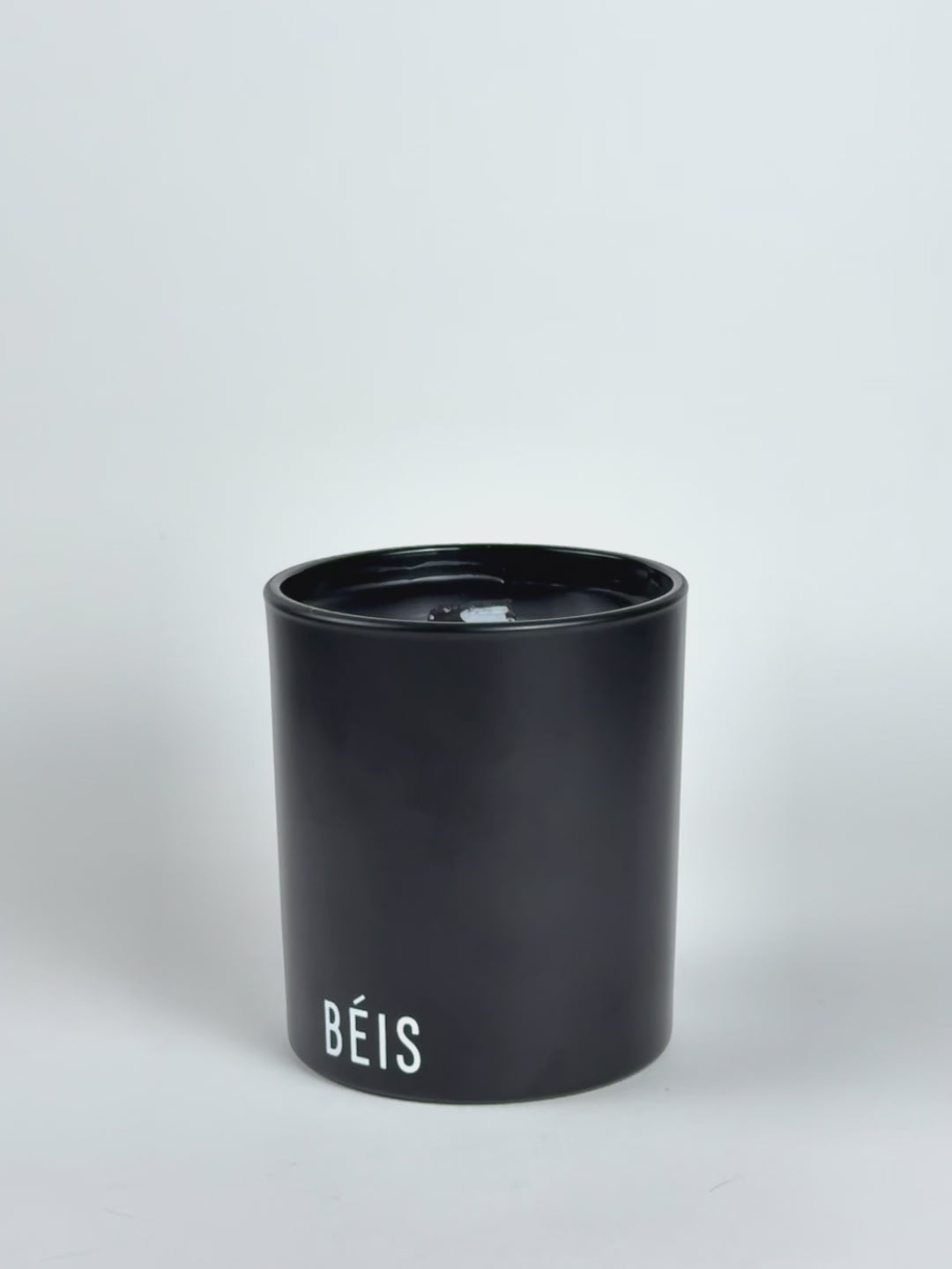 Black Luxury Printed Candle being lit product shot.