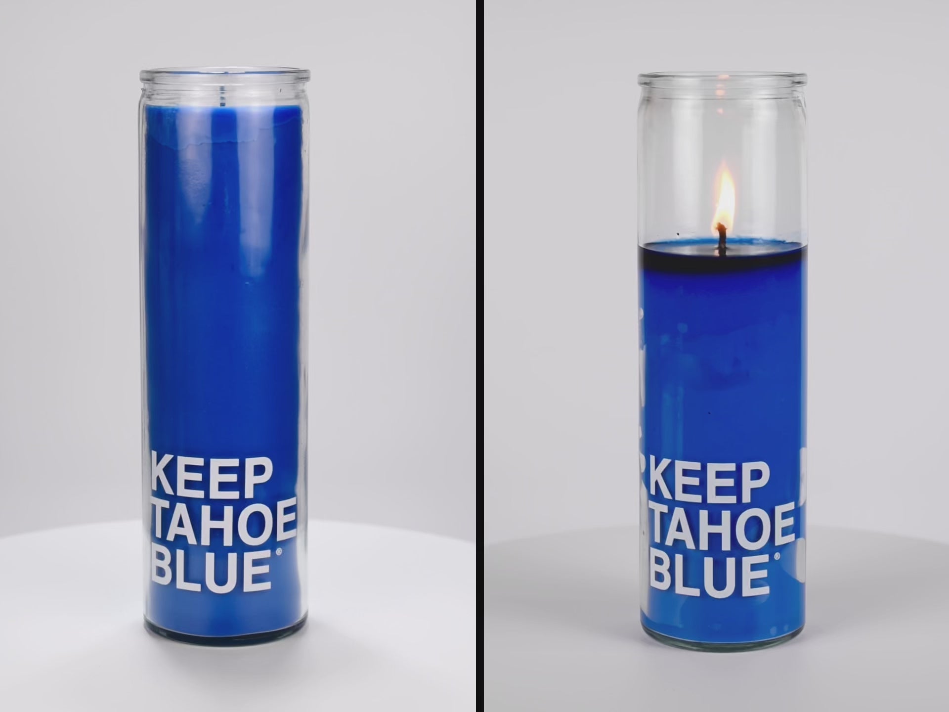 Load video: Two 16 oz Prayer Candles from Custom Candles LA filled with blue wax in a tall glass container spinning side by side. The left candle is unlit, and the right candle is lit and burned halfway down. The candles are printed with the words &quot;KEEP TAHOE BLUE&quot; in white letters across the bottom of the candle. 