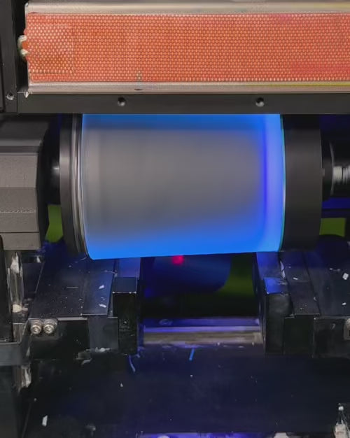 Load video: example of high speed rotational direct to surface printing process onto amber glass candle vessels