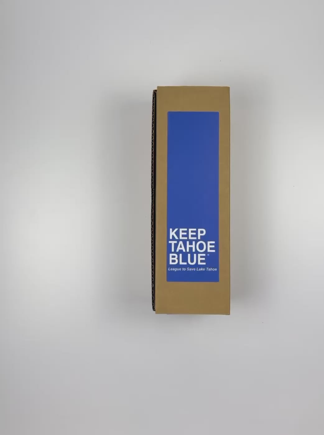 Load video: An unboxing video of the 16 oz Prayer Candle from Custom Candles LA filled with blue wax that comes in a Kraft mailer box with a blue sticker label of the logo artwork.The candle is printed with the words &quot;KEEP TAHOE BLUE&quot; in white letters across the bottom of the candle.