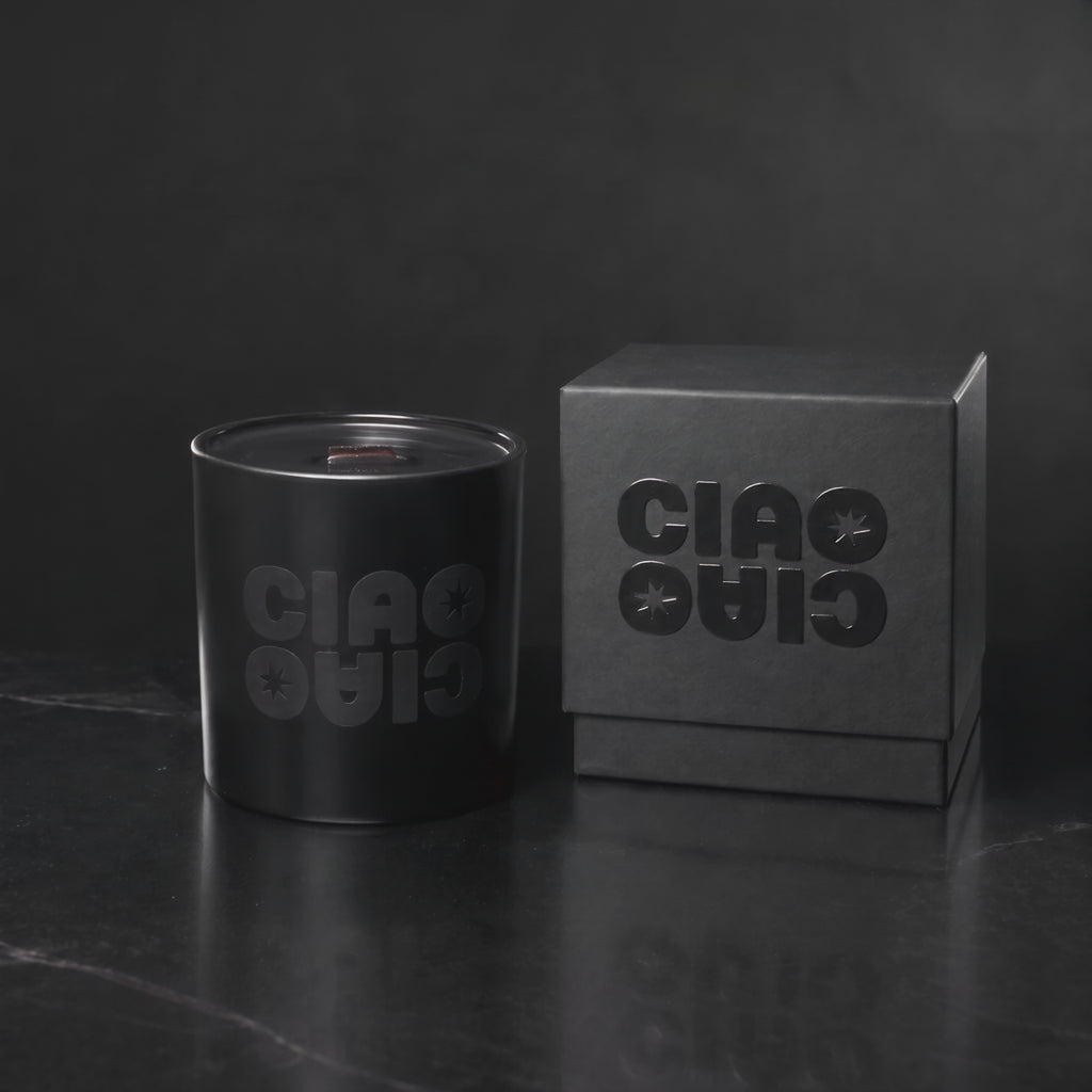 Matte Black 14 oz. Luxury Printed Candle with a tone-on-tone CIAO CIAO logo, lit.