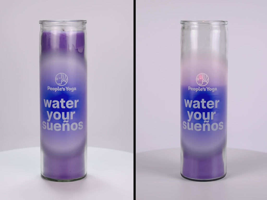 Two 16 oz Prayer Candles from Custom Candles LA filled with purple wax in a tall glass container spinning side by side. The candles are printed with a white "People's Yoga" logo and underneath it reads "water your suenos" in white. Behind the letters is a blue circle and fades into a lighter purple color. You can see the purple wax through the glass.