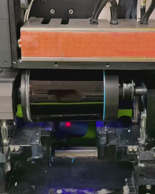 Load video: example of high speed rotational direct to surface printing process onto amber glass candle vessels