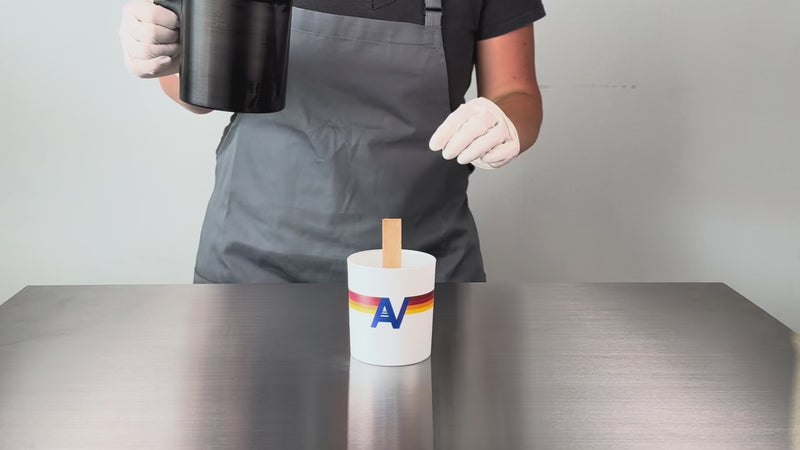 wide shot example video of wax pouring into a printed white glass candle