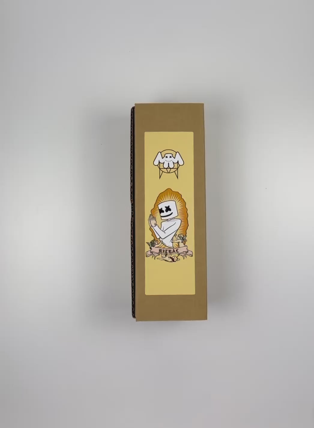Load video: An unboxing video of the 16 oz Prayer Candle from Custom Candles LA filled with orange wax that comes in a Kraft mailer box with a yellow sticker label of the logo artwork. The candle is printed with an image of a person praying. The head of the person is marshmallow shaped with black Xs as eyes and a smile. Below the person there is a banner that reads &quot;RITUAL&quot; and the person is surrounded by three cherubs. There is a spikey border around the artwork and the orange wax shows through. 